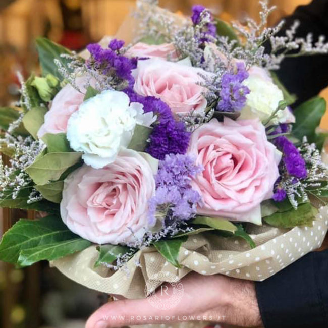 Donna Concetta Bouquet di fiori - dai toni bianco, rosa e lilla: Sweet Avalanche+, Statice Limonio Limonium lilla, bianco, viola, Lisianthus bianco, accuratamente confezionato con verde decorativo di stagione.